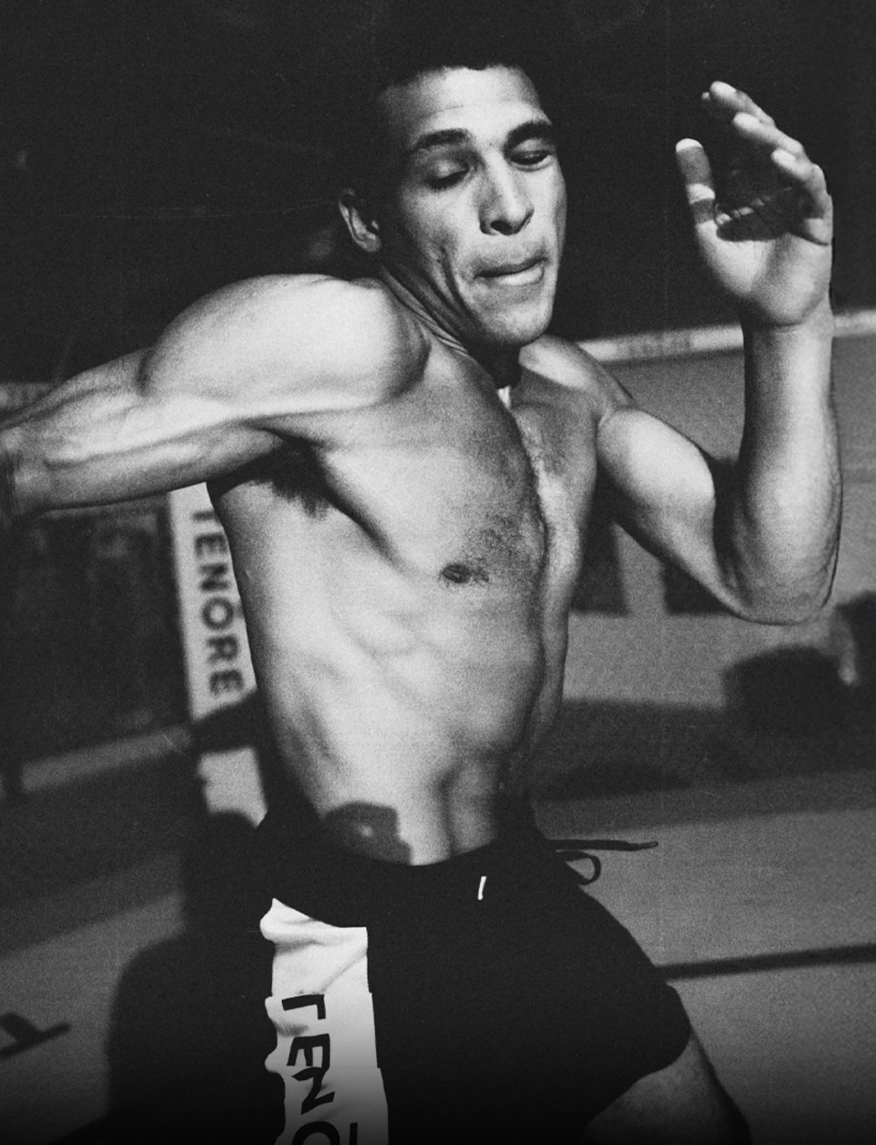 Fighter shadowboxing in a gym, in black and white