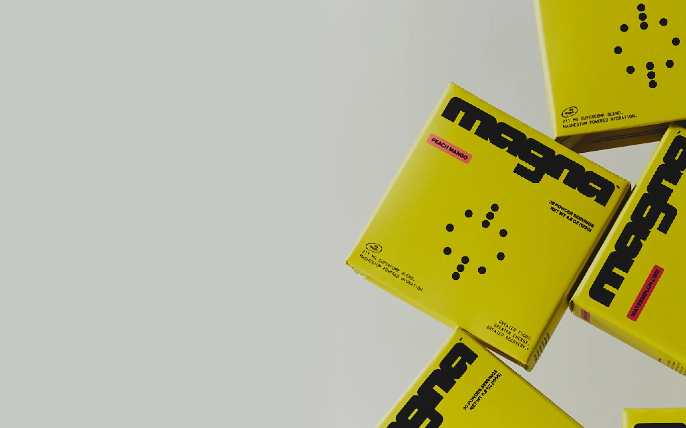 Yellow magna boxes, Peach Mango and Watermelon Lime, tumbling across a grey backdrop