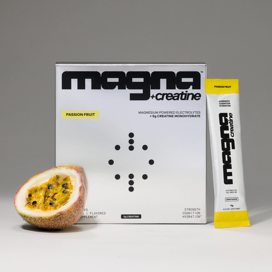 magna creatine Passion Fruit box with stick pack and a halved passion fruit